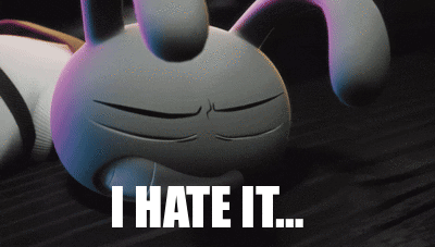 A Cartoon Bunny Is Laying On The Floor With The Words " I Hate It " Below It GIF