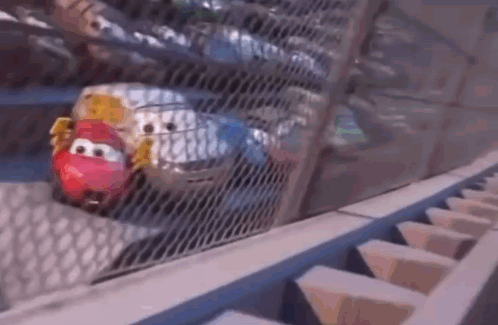 A Cartoon Car Is Driving Down A Roller Coaster Track . GIF