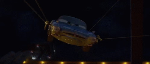 A Cartoon Car Is Flying Through The Air In Front Of A Fire GIF