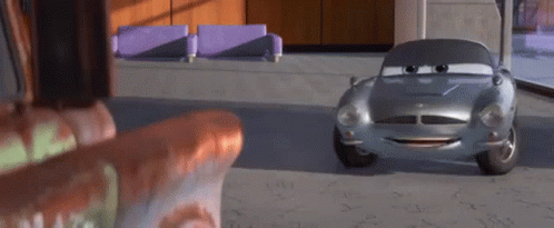 A Cartoon Car Is Sitting In A Room Next To A Couch And A Chair . GIF