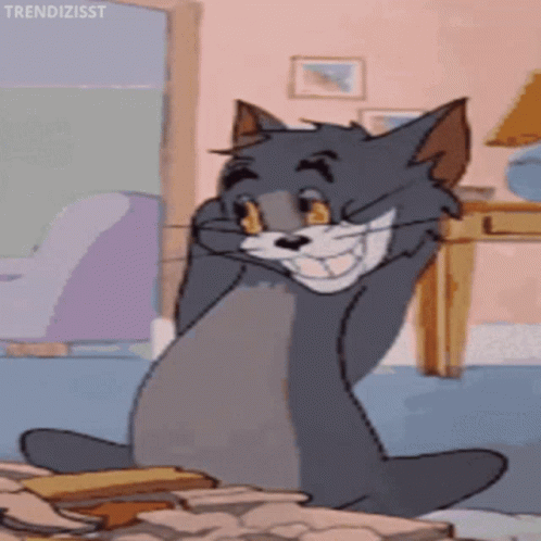 A Cartoon Cat Is Sitting On A Pile Of Papers And Making A Funny Face . GIF