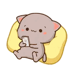 a cartoon cat is sitting on a pillow and holding a cell phone .