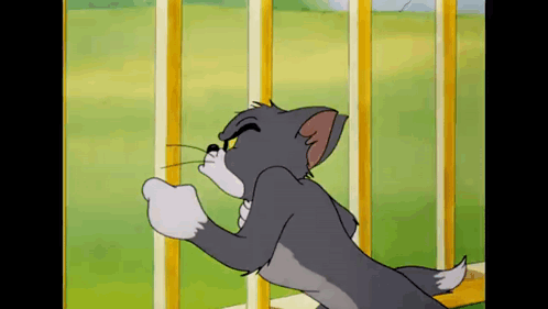 A Cartoon Cat Is Standing Next To A Fence And Looking At Something . GIF