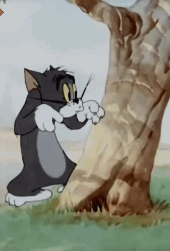 A Cartoon Cat Standing Next To A Tree GIF