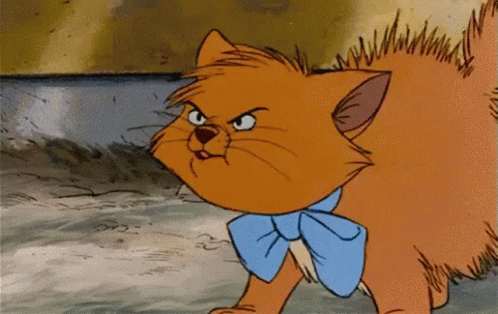 A Cartoon Cat Wearing A Blue Bow Tie Is Looking Angry GIF