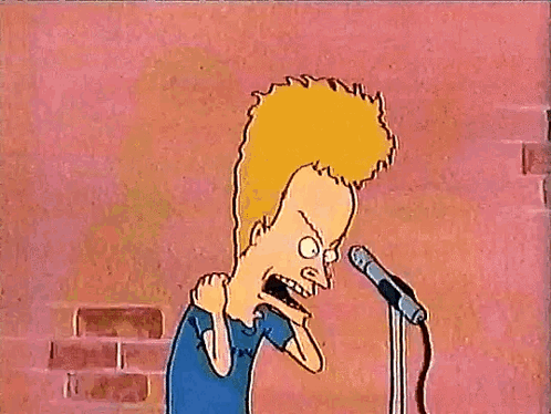 A Cartoon Character From Beavis And Butthead Is Standing In Front Of A Microphone With His Arms In The Air . GIF