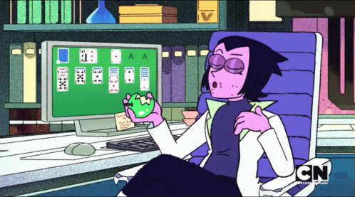 A Cartoon Character From Cn Sits In Front Of A Computer Screen Playing Solitaire GIF