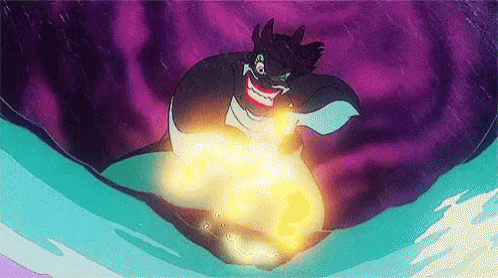 A Cartoon Character From The Little Mermaid Is Holding A Glowing Object In Her Hands . GIF