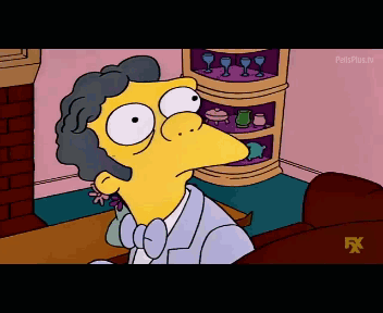 A Cartoon Character From The Simpsons Is Sitting On A Couch In Front Of A Fireplace GIF