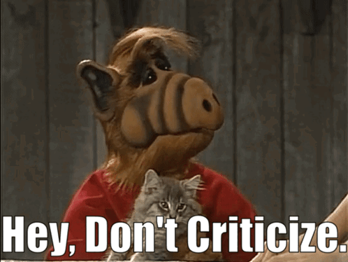 A Cartoon Character Holding A Kitten With The Words Hey Don 'T Criticize GIF
