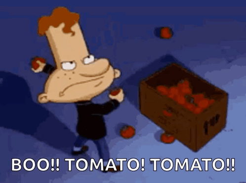 A Cartoon Character Holding A Tomato Next To A Box Of Tomatoes That Says Boo Tomato Tomato GIF
