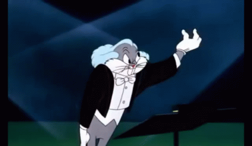 A Cartoon Character In A Tuxedo Is Holding A Pie In Front Of His Face GIF