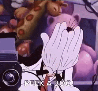 A Cartoon Character Is Covering His Face With His Hands In Front Of A Projector . GIF