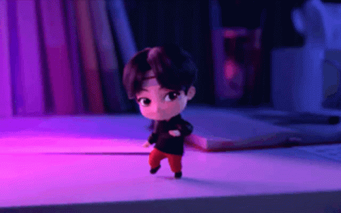 A Cartoon Character Is Dancing On A Table In A Room With Purple Lights . GIF