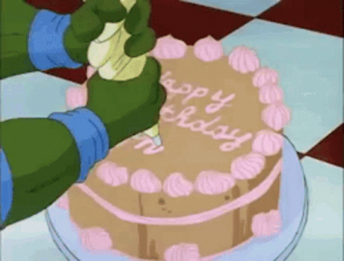 A Cartoon Character Is Frosting A Cake That Says Happy Birthday On It GIF