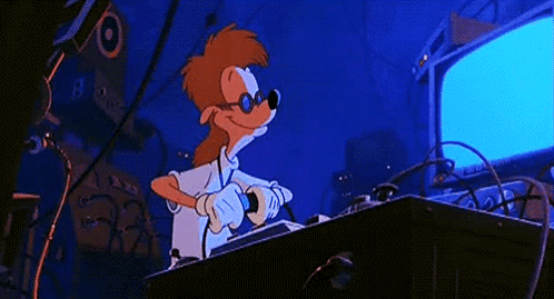 A Cartoon Character Is Giving A Thumbs Up While Sitting At A Desk GIF