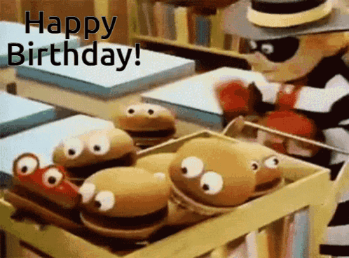 A Cartoon Character Is Holding A Box Of Stuffed Animals And Says Happy Birthday GIF