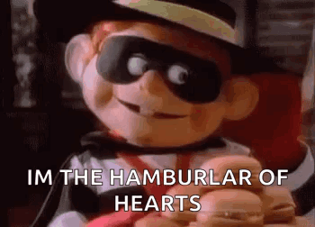 A Cartoon Character Is Holding A Bunch Of Hamburgers And Saying `` Im The Hamburglar Of Hearts '' . GIF