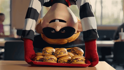 A Cartoon Character Is Holding A Tray Of Cheeseburgers GIF