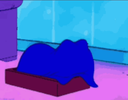 A Cartoon Character Is Laying In A Box With The Letter G On The Top GIF