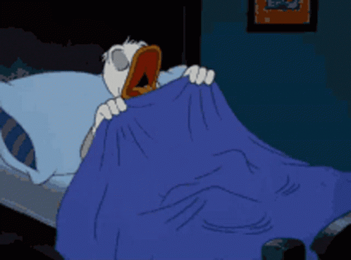 A Cartoon Character Is Laying In Bed With A Blue Blanket GIF