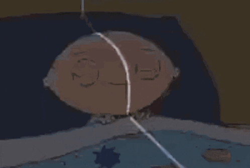 A Cartoon Character Is Laying In Bed With A Blue Blanket . GIF