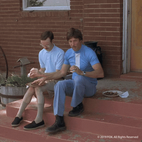 A Cartoon Character Is Laying In The Grass With His Head On His Arms . GIF