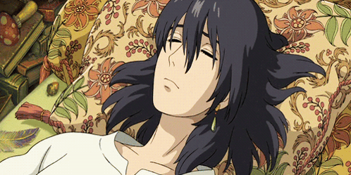 A Cartoon Character Is Laying On A Couch With A Floral Pillow GIF