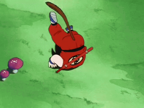 A Cartoon Character Is Laying On His Back In The Grass With A Stick In His Hand . GIF