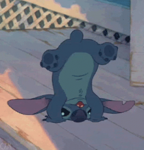 A Cartoon Character Is Laying Upside Down On A Wooden Floor GIF