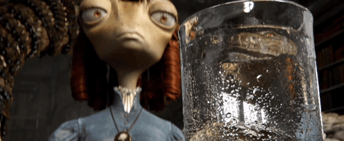 A Cartoon Character Is Looking At A Glass Of Liquid GIF