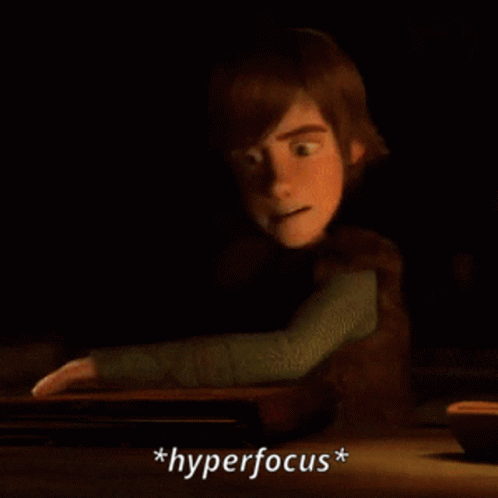 A Cartoon Character Is Reading A Book And The Word Hyperfocus Is Below Him GIF