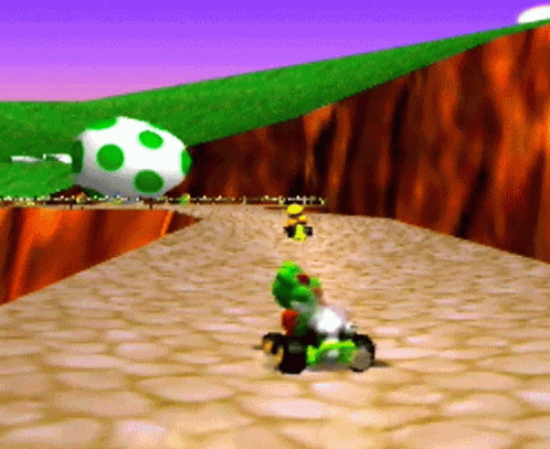 A Cartoon Character Is Riding A Kart On A Rocky Road . GIF