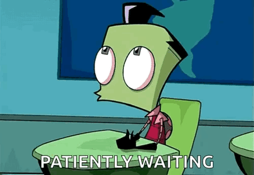 A Cartoon Character Is Sitting At A Desk With The Words Patiently Waiting Below Him . GIF