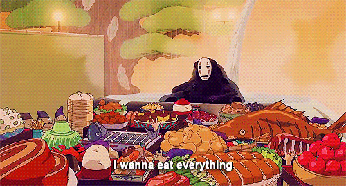 A Cartoon Character Is Sitting At A Table With A Lot Of Food . GIF