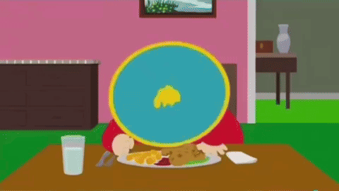 A Cartoon Character Is Sitting At A Table With A Plate Of Food On It . GIF