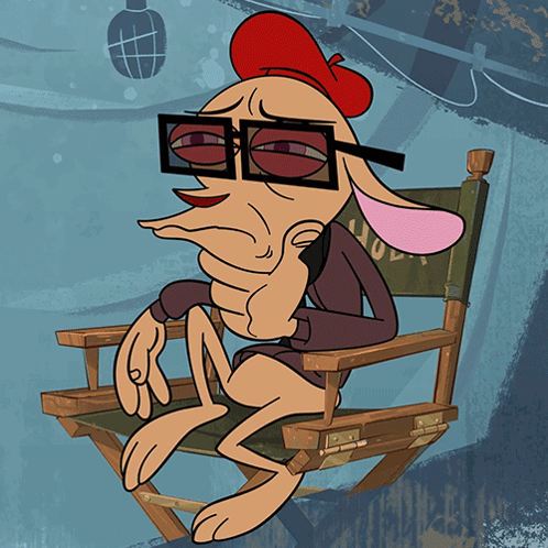 A Cartoon Character Is Sitting In A Directors Chair GIF