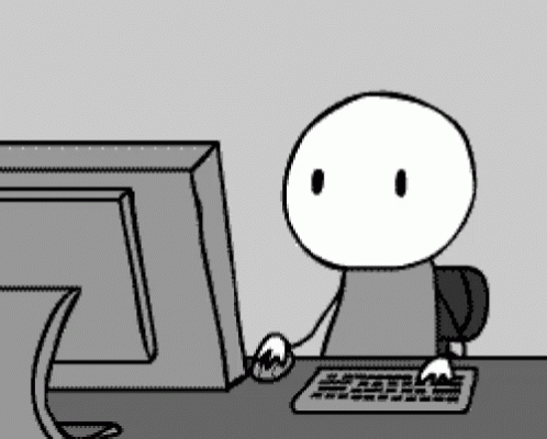 A Cartoon Character Is Sitting In Front Of A Computer Monitor GIF