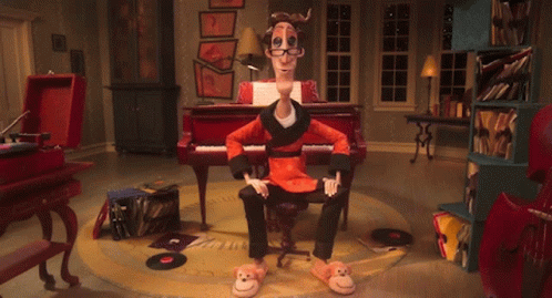 A Cartoon Character Is Sitting In Front Of A Piano And Has A Pair Of Monkey Slippers On GIF