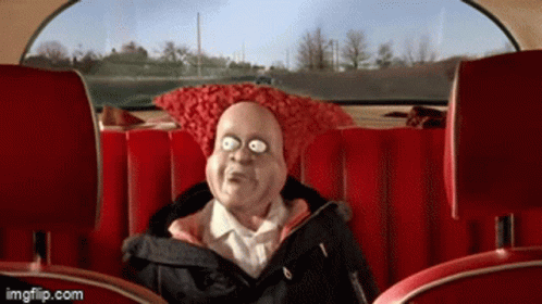 A Cartoon Character Is Sitting In The Back Seat Of A Car With A Red Pillow On His Head GIF