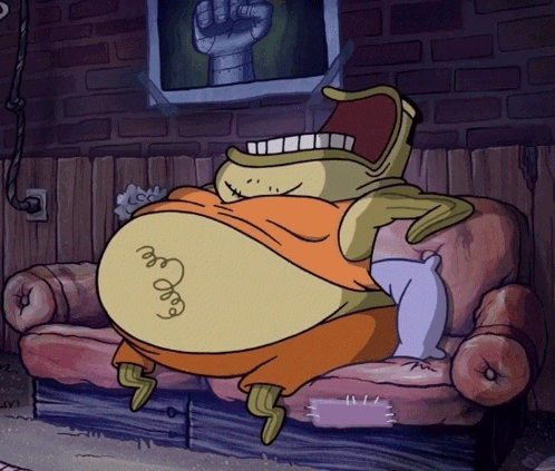 A Cartoon Character Is Sitting On A Couch With A Picture Of A Fist Behind Him GIF