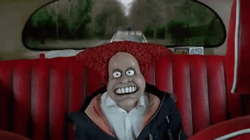 A Cartoon Character Is Sitting On A Red Couch In A Car With A Big Smile On His Face . GIF