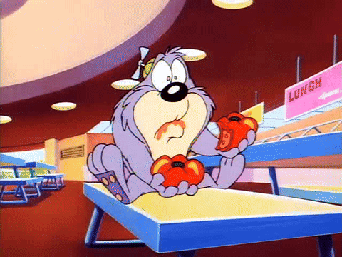 A Cartoon Character Is Sitting On A Table Eating Tomatoes In A Cafeteria . GIF