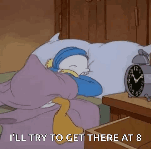A Cartoon Character Is Sleeping In A Bed With An Alarm Clock Next To Him . GIF