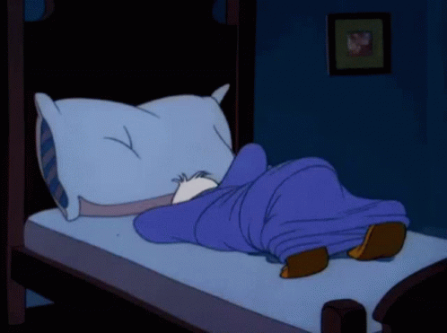 A Cartoon Character Is Sleeping On A Bed With A Pillow And A Blue Blanket GIF