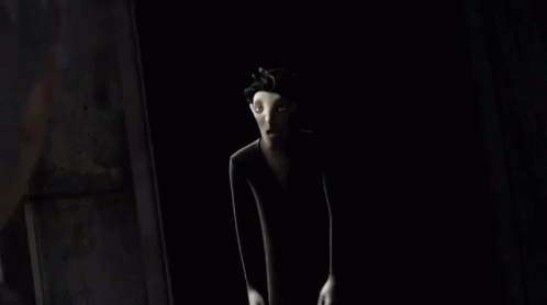 a cartoon character is standing in a dark room .