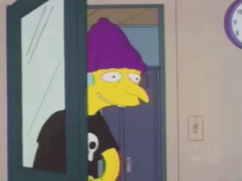 A Cartoon Character Is Standing In A Doorway Wearing A Purple Hat And Headphones . GIF