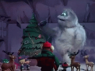 A Cartoon Character Is Standing In Front Of A Christmas Tree And Reindeer . GIF
