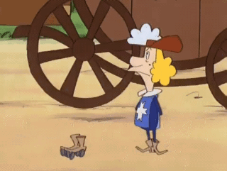 A Cartoon Character Is Standing In Front Of A Wagon Wheel GIF
