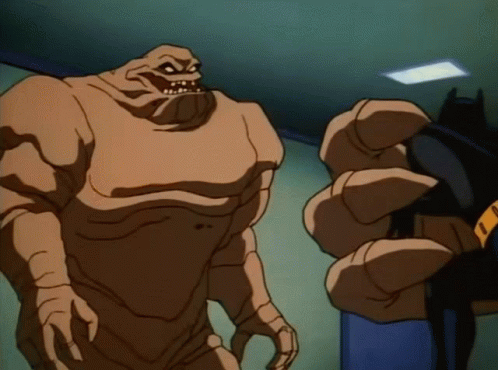 A Cartoon Character Is Standing Next To A Batman GIF